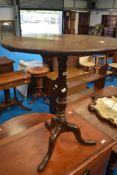 A 19th century oak tripod table having turned column and triple splay legs, diameter approx 68cm.