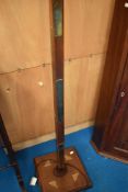 An early to mid 20th Century mahogany standard ;lamp , having brass decoration