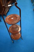 An early 20th Century mahogany three tier folding cake stand