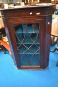 A 19th Century mahogany cupboard having glazed door