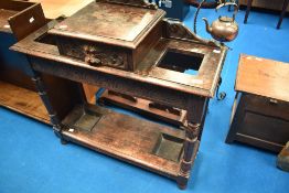 A late 19th Century oak hall stand having storage drawer with green man mask carved handle