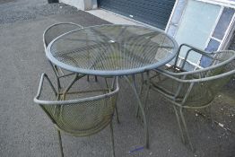 A modern metal garden table and four chairs