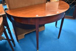 A 19th Century mahogany demi lune table on square tapered legs with extending flap, width approx.