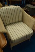 A modern Lloyd Loom tub chair with cushions