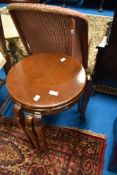 A mid 20th Century oak nest of three circular tables