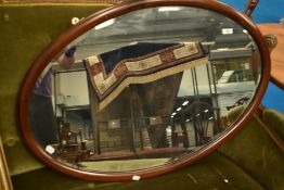 An Edwardian mahogany oval wall mirror