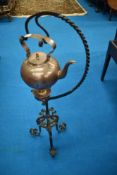 A Victorian copper spirit kettle on wrought iron stand