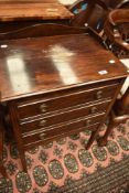 A Regency revival three drawer music cabinet, having stained frame.