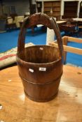 A decorative wooden milk pail