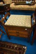 An early 20th Century stained frame piano stool with drawer storage