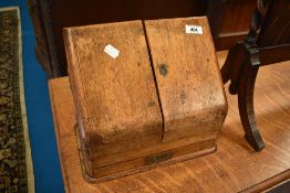 A campaign style golden oak stationery rack with drawer, width approx 31cm