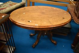 A 19th Century loo table of oval form with quarter veneered top having inlaid foliate decoration