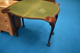 A late 19th or early 20th Century mahogany fold over card table having shaped top and legs, having