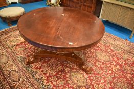 A 19th Century mahogany dining table having circular tilt top on William IV style trefoil base,