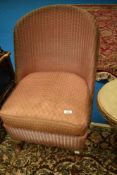 A vintage Lloyd Loom nursing chair with upholstered seat