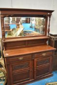 A late 19th / early 20th century mahogany sideboard, having mirrored back, flanked by knopped