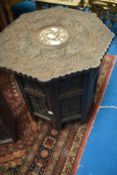A Middle Eastern style carved occasional table of folding form