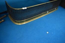 A vintage pierced brass fire fender