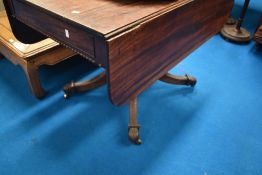 A 19th century mahogany sofa table, having drawers to both ends, on turned column and quatrefoil