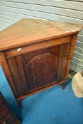 A traditional oak corner cupboard base