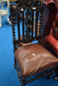 A 19th Century Carolean revival dining chair having 'green man' and foliate decoration to back