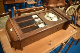 An early 20th Century oak cased wall clock having Arabic numeral dial