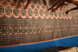 A modern carpet square having pink ground
