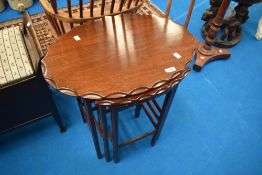 An early to mid 20th Century mahogany nest of three tables