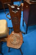A traditional oak spinning chair having carved rosette decoration