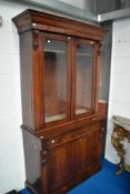 A Victorian mahogany bookcase having drawer and double cupboard to base