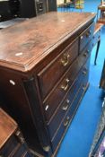 A 19th Century oak chest of two over three drawers having quarter column supports and brass drop