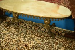 A vintage onyx and gilt metal coffee table of oval form , approx. 117 x 50cm