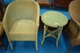 A vintage Lloyd Loom tub chair and a similar side table having circular glass top