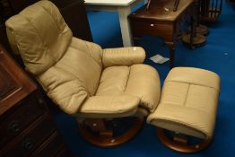 A stressless recliner chair and stool , in cream
