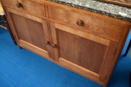 A golden oak side cabinet with grey marble top, dimensions approx. W107 D46 H75cm