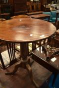 A 19th Century mahogany pedestal occasional table having circular top on turned column and triple
