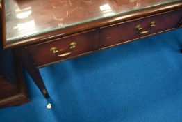 A mahogany coffee table with glass top and drawer storage, approx 106 x 61cm
