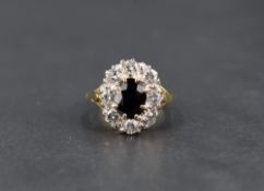 A sapphire and diamond cluster ring having a central oval sapphire within a surround of eight