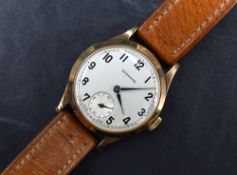 A gent's vintage 9ct gold manual wrist watch by Garrard having Arabic Numeral dial with subsidiary