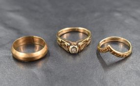 Three 9ct gold rings including wedding band, wishbone and diamond chip solitaire, approx 8.2g total