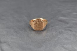 A 9ct gold signet ring, the rectangular panel with textured surface and floral engraving, ring
