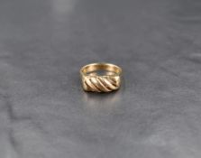 A yellow metal ring having open twist detail, no marks but presumed 9ct gold, size L & approx 2.8g