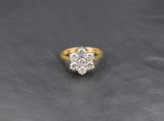 An 18ct diamond cluster ring, the seven round brilliant cut diamonds measuring approximately 0.