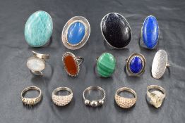 Fourteen white metal rings, most stamped 925 of various designs including polished stone, some