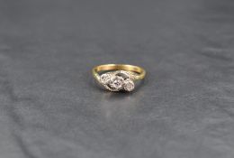 An 18ct diamond trilogy ring, having illusion set diamonds with twist shoulders, ring size P-O, 3.