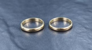 Two yellow metal wedding bands of plain form tamped 9ct, both size R & approx 7.6g total