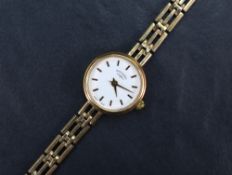 A 9ct gold Rotary wristwatch, the white dial having baton five minute markers, on a 9ct gold