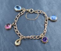 A 9ct gold curb link bracelet, having five gemstone charms with safety charm, approximately 16cm