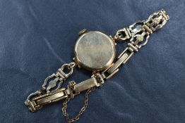 A 9ct gold cased Rotary wristwatch, the champagne dial with baton and Arabic numerals, on a 9ct gold