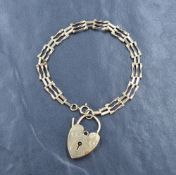 A 9ct gold three bar gate bracelet, sold along with a 9ct gold heart padlock, approximately 18.5cm